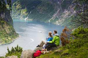 Couple enjoying the view of Geirangerfjord by CH, Visit Norwa