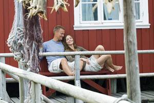 Couple relaxing on Lofoten Islands by CH, Visit Norway