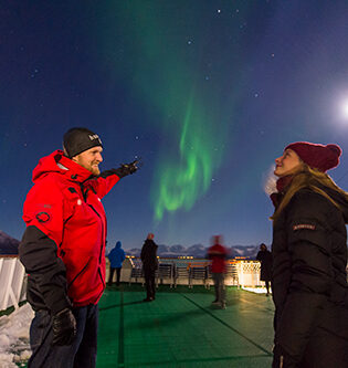 Tourists enjoying the Northern Lights on board MS Nord-Norge