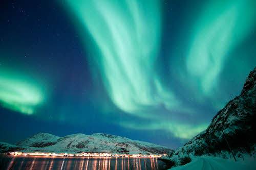 Northern Lights illuminating the sky in Tromso by Gaute Bruvik, Visit Norway