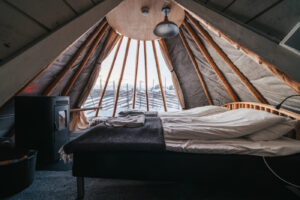 Inside bed and glass wall in tipi by Holmen Husky Lodge